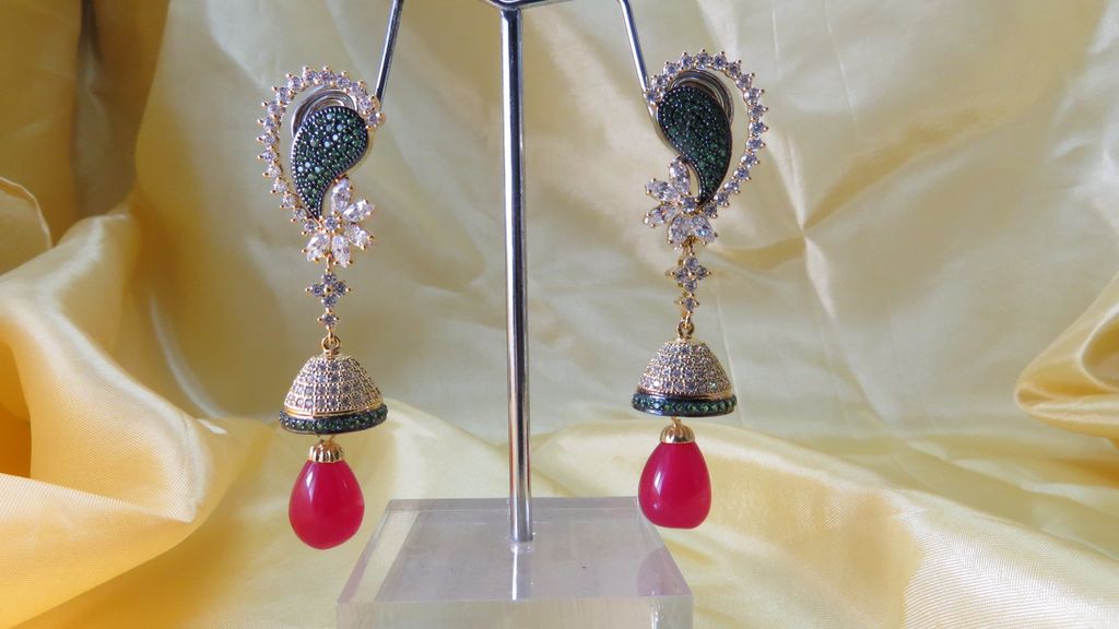 jhumki earrings in ad with ruby bead dangling